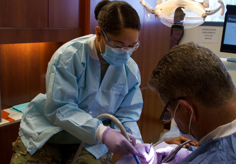 Spc. Cleopatra Matthews, a dental specialist with the 7239th Medical Support Unit, Chattanooga, Tennessee, assists Lt. Col. Joseph Largeman, a general dentist with the 7236th Medical Support Unit, Fort Benning, Georgia, with a lower molar filling and upper tooth extraction at the Chief Redstone Health Clinic at Wolf Point, Montana, July 17, 2017. During the two-week-long mission Fort Peck Innovative Readiness Training, Army Reserve Soldiers will collaborate with the Indian Health Service to provide medical and dental care to an estimated population of over 8,000 residents. (U.S. Army Reserve photo by Spc. Claudia Rocha  345th Public Affairs Detachment)