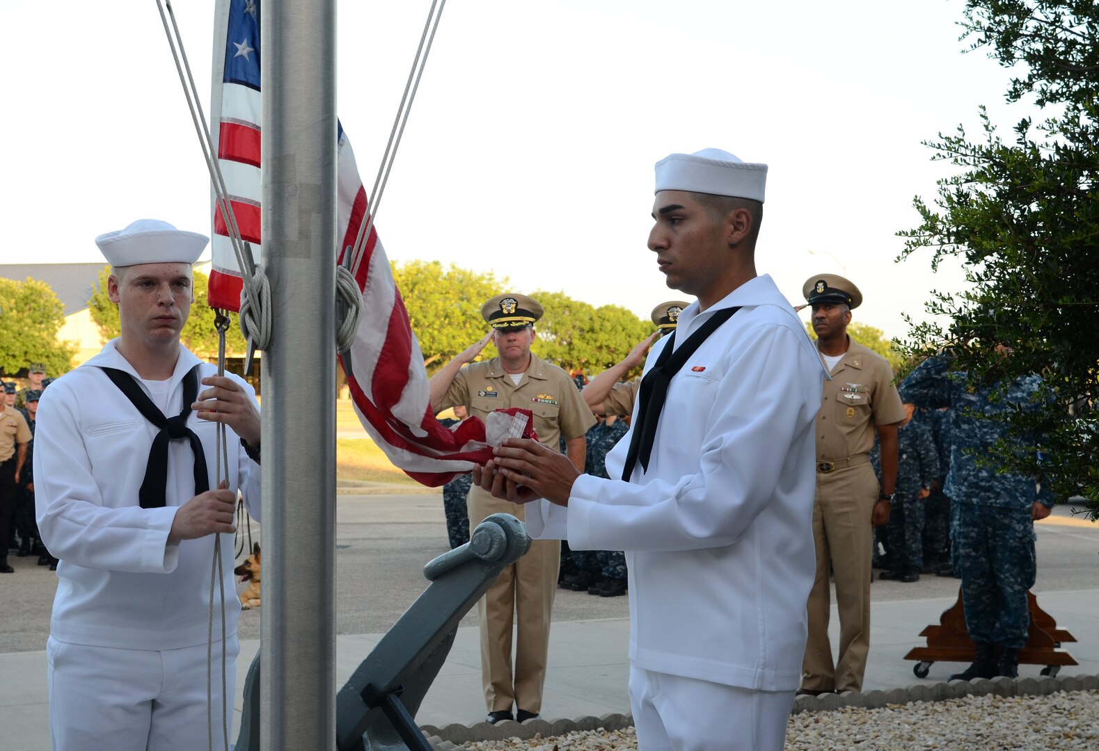Naval Technical Training Center Lackland students and staff observe the colors during the Fallen Hero's Ceremony July 21, 2017. The ceremony was held in remembrance of Petty Officer 2nd Class Michael J. Brodsky, Naval Technical Training Center Lackland master-at-arms and military working dog handler, who died July 21, 2012, during Operation Enduring Freedom from injuries caused by an improvised explosive device. (U.S. Navy Photo by Chief Petty Officer Sara Horvath/Released)