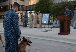 Petty Officer 2nd Class Nicholas Graham, Naval Technical Training Center Lackland master-at-arms and military working dog handler, and Aanie, MWD, observe a moment of silence during a ceremony July 21, 2017, held in remembrance of Petty Officer 2nd Class Michael J. Brodsky, Naval Technical Training Center Lackland master-at-arms. Brodsky was a MWD handler who died July 21, 2012, during Operation Enduring Freedom from injuries caused by an improvised explosive device. (U.S. Navy Photo by Chief Petty Officer Sara Horvath/Released)