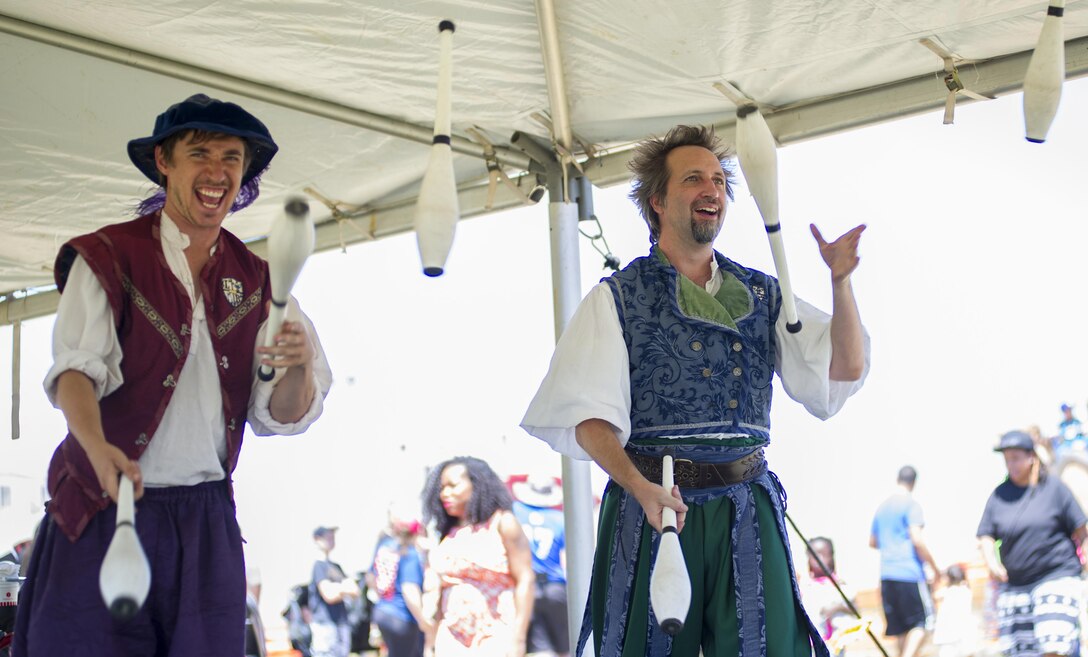 SCHRIEVER AIR FORCE BASE, Colo. -- A.J. Lee and Louie Skaradek, members of the London Broil Show, juggle pins at Schriever's 2017 Summer Slam Picnic on Friday, July 21, 2017. This years picnic offered an array of activities to Airmen and their families, including elephant rides, knockerballs and a rock wall. (U.S. Air Force photo/Senior Airman Laura Turner)