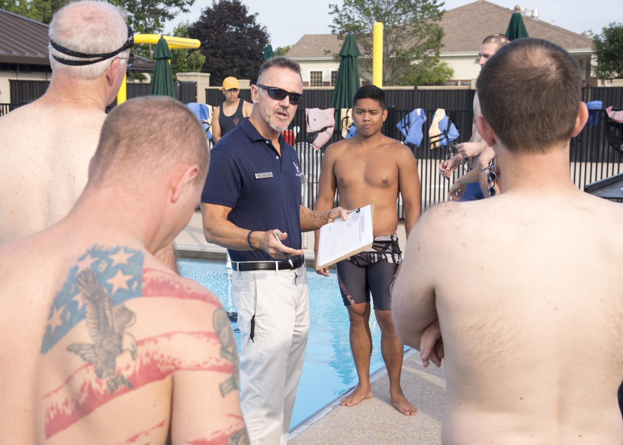 John Walters, 436th Force Support Squadron fitness program manager, talks to Special Ops Challenge participants during the event July 17, 2017, at the Oasis Pool on Dover Air Force Base, Del. Team Dover members entered the challenge which consisted of five events; the first being a 500-meter swim. (U.S. Air Force photo/Staff Sgt. Jared Duhon)