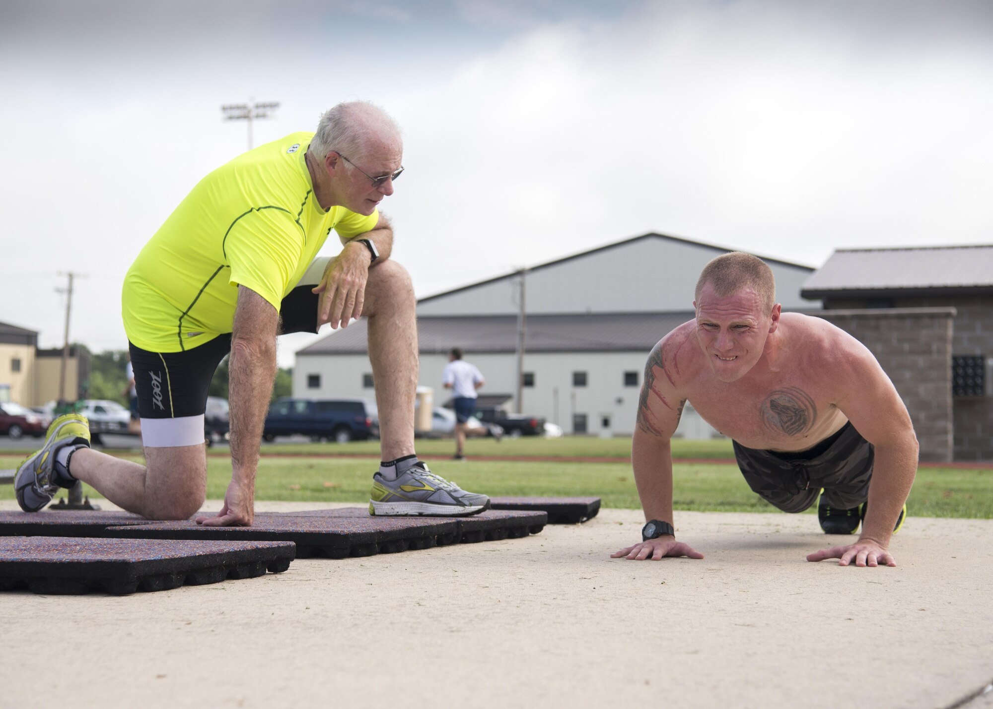 Team Dover Airmen complete push-ups during the Special Ops Challenge event July 17, 2017, at the base track on Dover Air Force Base, Del. Team Dover members entered the challenge consisting of five events that tested their speed and stamina. (U.S. Air Force photo/Staff Sgt. Jared Duhon)