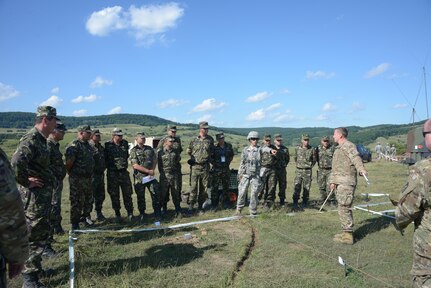 Capt. Peter Eulenstein, assistant S3, far right, and Spc. Gizela Lupescu, battalion translator, center right, plan live-fire exercise with Romanian army officers at a training area near Cincu, Romania, during Exercise Guardian Saber, July 9 - 11, 2017.  