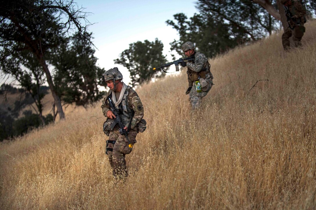 Army Reserve soldiers walk down a hill while on reconnaissance patrol during a combat support training exercise at Fort Hunter Liggett, Calif., July 21, 2017. Army Reserve photo by Master Sgt. Michel Sauret