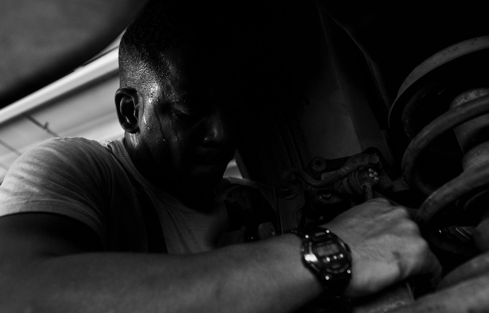Staff Sgt. Seibenthauler Lodge, 27th Special Operations Civil Engineer Squadron pavement and construction equipment operator, works on his friend’s car at the Cannon Air Force Base Auto Hobby Shop, N.M., Jul. 11, 2017. Lodge tries to return to the shop at least once a month, either to help his friend fix his vehicle or to work on his own. (U.S. Air Force photo by Senior Airman Lane T. Plummer)