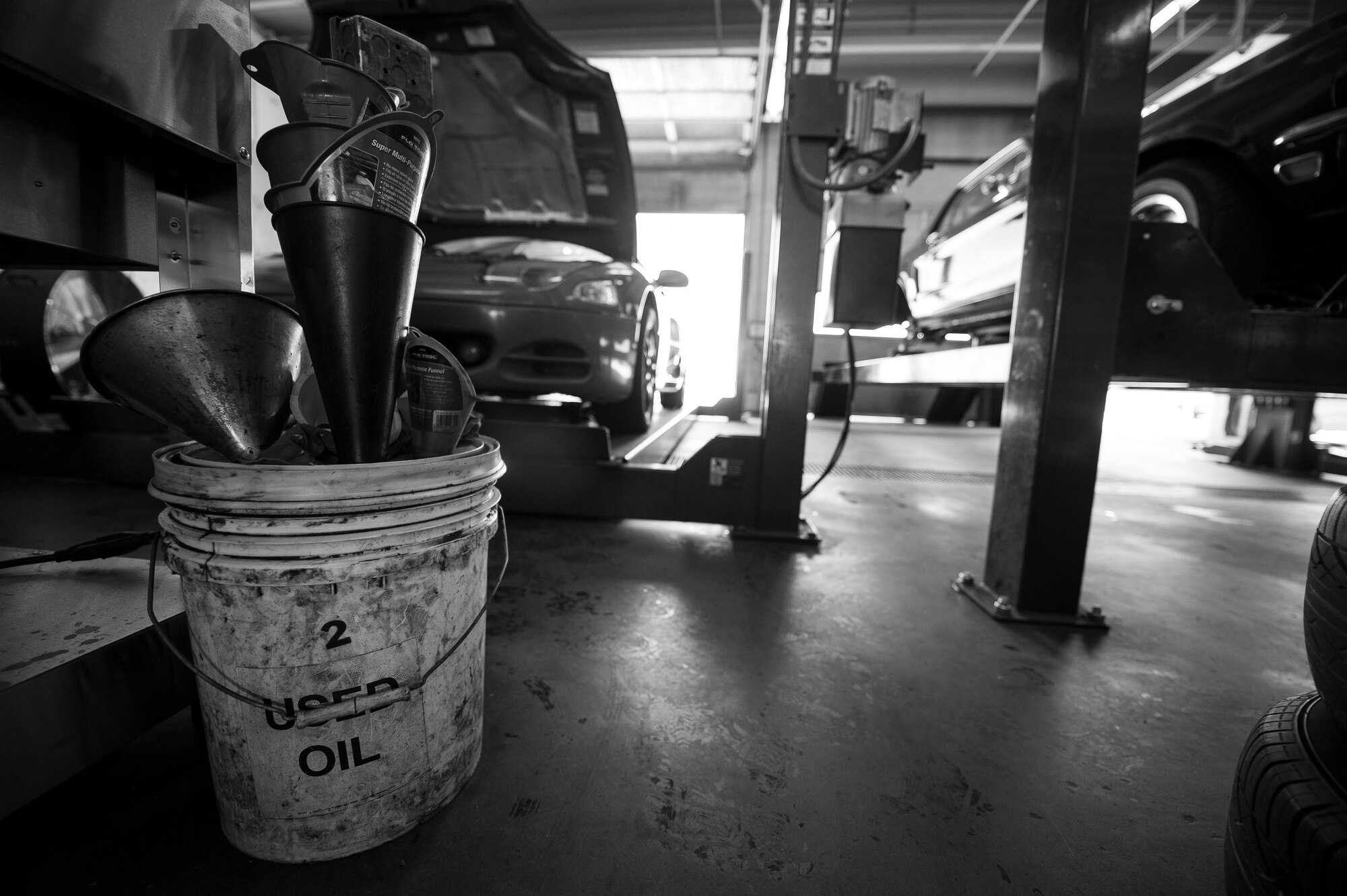 Oil funnels sit in a bucket in the auto skills center at Cannon Air Force Base, N.M., Jul. 12, 2017. Airmen are given a large amount of tools and other maintenance supplies to work on their vehicles. (U.S. Air Force photo by Senior Airman Lane T. Plummer)