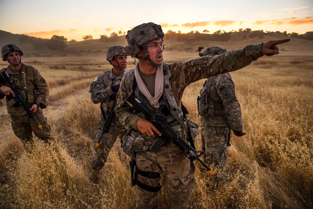 An Army Reserve soldier points to a hill where enemy forces were spotted during a combat support training exercise at Fort Hunter Liggett, Calif., July 21, 2017. Army Reserve photo by Master Sgt. Michel Sauret 