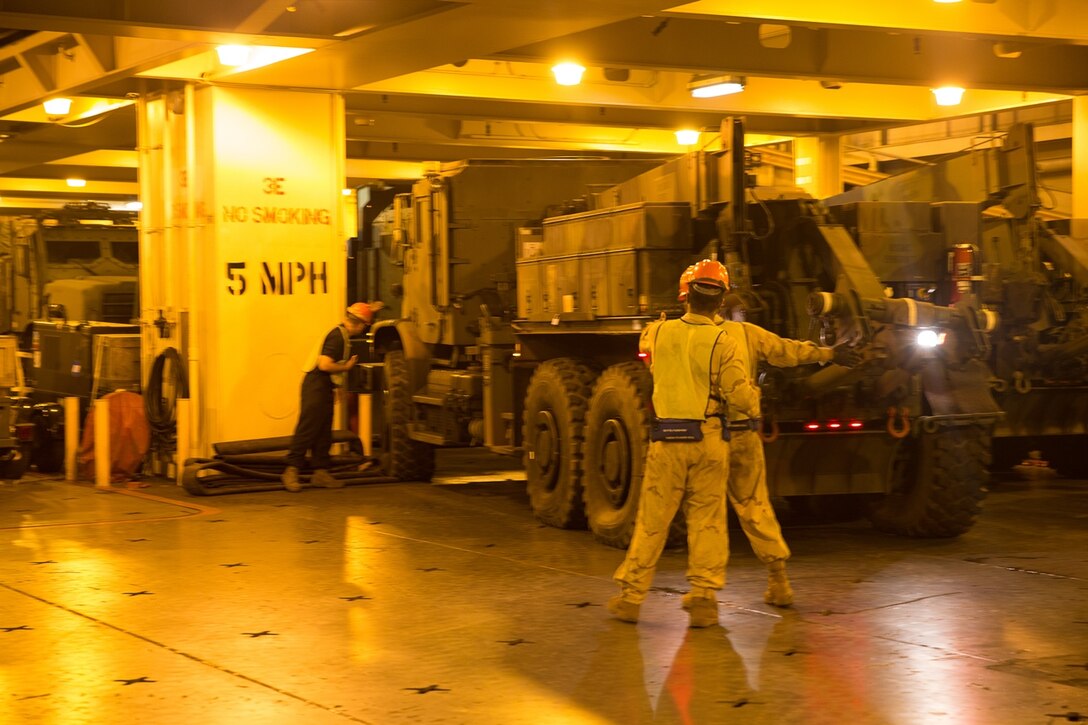 US Marines with 1st Marine Logistics Group guide a Medium Tactical Vehicle Replacement (MTVR) MK36 into its proper place aboard USNS Dahl during Pacific Horizon 2017, July 18, 2017. Pacific Horizon 2017 is a Maritime Prepositioning Force (MPF) exercise designed to train I Marine Expeditionary Force (MEF) and components of Naval Beach Group 1 (NBG-1) Marines and Sailors on arrival and assembly operation as well as follow-on Marine Air Ground Task Force actions to ensure that the right equipment, supplies and tools get to the right people to be employed in a crisis response, humanitarian assistance or amassing combat power ashore from sea. (U.S. Marnie Corps photo by Sgt. Rodion Zabolotniy)