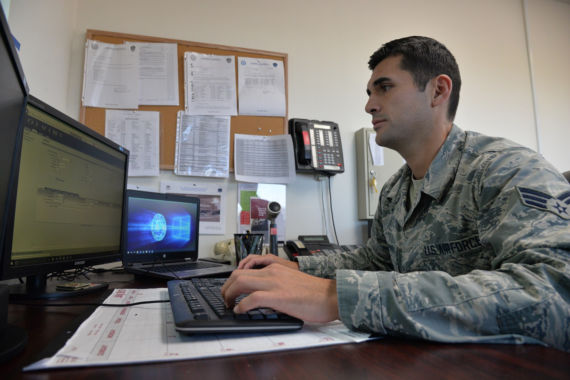 Senior Airman Felipe Vilches-Hernandez, 341st Logistics Readiness Squadron licensing and vehicle operator, uses the online vehicle management system July 19, 2017, at Malmstrom Air Force Base, Mont. The system is used to input personnel information and make military vehicle licenses for Airmen. (U.S. Air Force photo/Airman 1st Class Daniel Brosam)