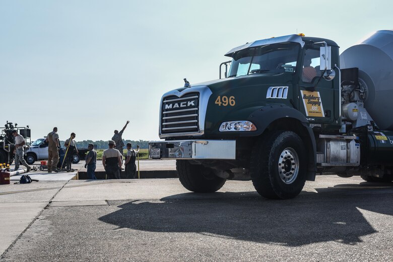 The 2nd Civil Engineer Squadron Dirt Boyz fill concrete into an emptied slab at Barksdale Air Force Base, La., July 18, 2017. The Airmen fixed five slabs of concrete, a project totaling $170,000 and two months of work. (U.S. Air Force Photo/Airman 1st Class Sydney Bennett)