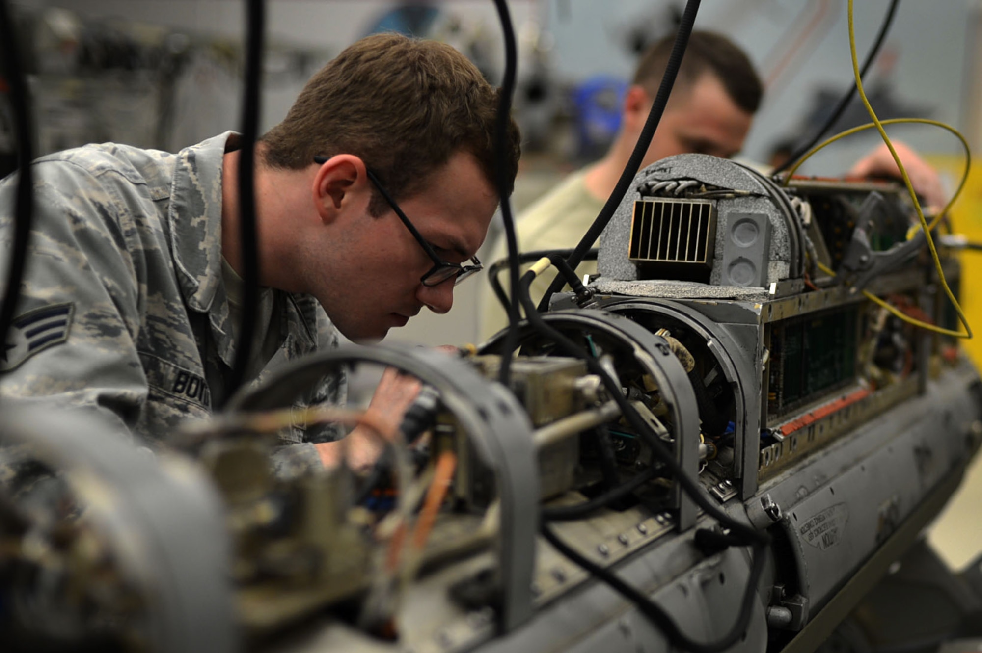 U.S. Air Force Senior Airman Joshua Boyd, 20th Component Maintenance Squadron electronic warfare (EW) team member, inspects an AN/ALQ-184 electronic countermeasure (ECM) pod at the EW work center at Shaw Air Force Base, S.C., July 21, 2017. The ECM pod provides aircraft with the technology necessary to avoid being targeted by incoming missiles. (U.S. Air Force photo by Senior Airman Christopher Maldonado)