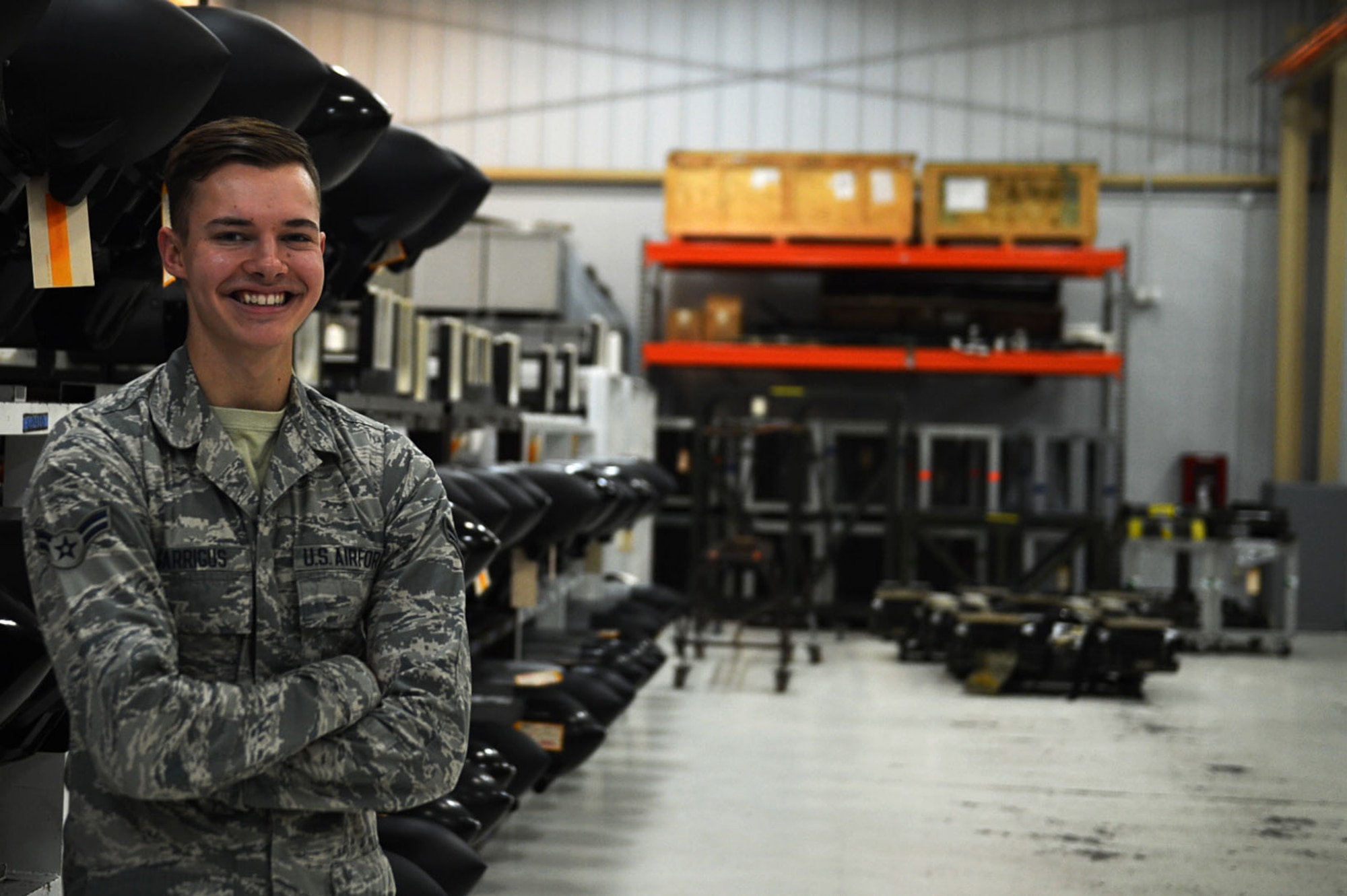 U.S. Air Force Airman 1st Class Austin Garrigus, 20th Component Maintenance Squadron (CMS) electronic warfare (EW) team member, stands in front of rows of AN/ALQ-184 electronic countermeasure pods at Shaw Air Force Base (AFB), S.C., July 21, 2017. Airmen assigned to the 20th CMS EW flight perform maintenance on 141 ECM pods for Shaw and the 23rd Wing at Moody AFB, Ga. (U.S. Air Force photo by Senior Airman Christopher Maldonado)