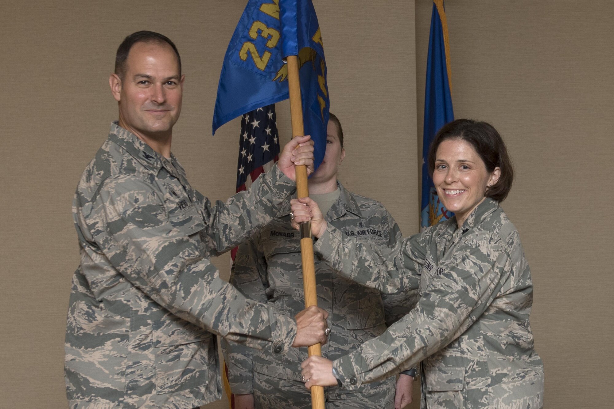 Col. Jay Vietas, left, 23d Medical Group commander, passes the guidon to Lt Col. Tracy K. Bozung, incoming 23d Aerospace Medicine Squadron commander, during a change of command ceremony, July 20, 2017, at Moody Air Force Base, Ga. The 23d AMDS oversees the individual medical readiness of approximately 4,000 active-duty members and the occupational health of roughly 5,500 industrial workers. (U.S. Air Force photo by Airman 1st Class Destiney Masse)