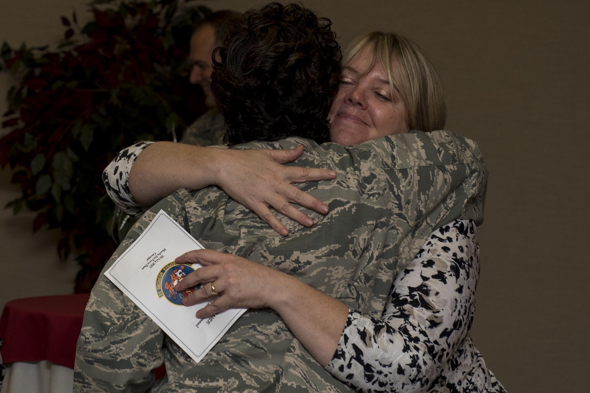 Col. Yvette Guzman, outgoing 23d Aerospace Medicine Squadron Commander, receives an embrace, July 20, 2017, at Moody Air Force Base, Ga. Guzman’s next assignment will be at Kirkland AFB, New Mexico, where she will serve as the Chief of the Inspection and Training Division. (U.S. Air Force photo by Airman 1st Class Destiney Masse)