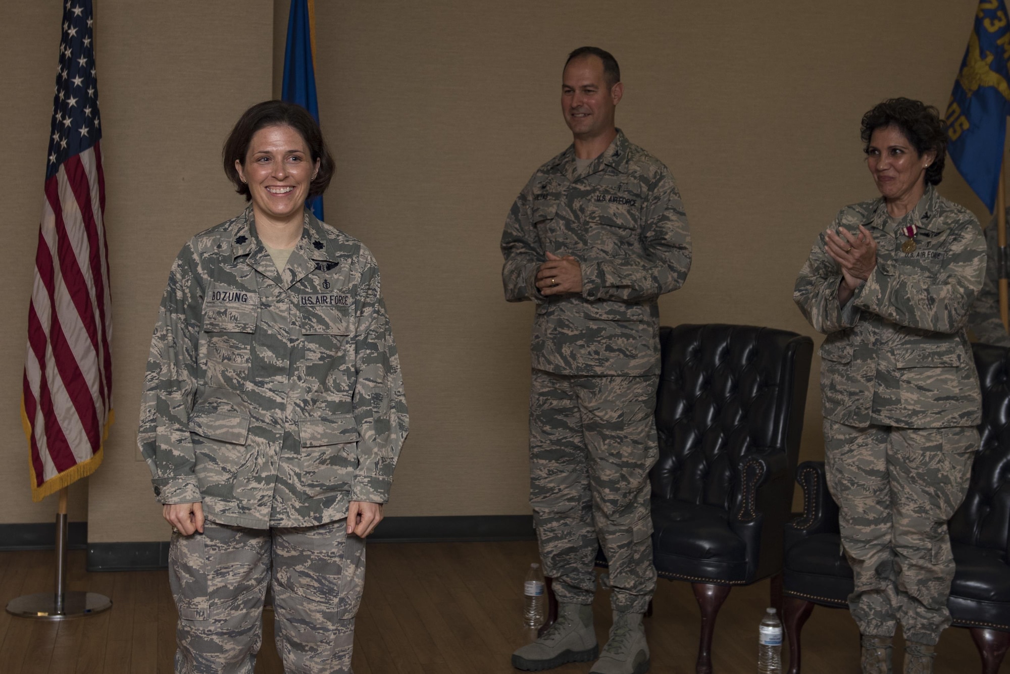Lt Col. Tracy K. Bozung, incoming 23d Aerospace Medicine Squadron Commander, smiles while receiving an ovation during a change of command ceremony, July 20, 2017, at Moody Air Force Base, Ga. Bozung entered active duty in 2000 after graduating first in her class from the United States Air Force Academy. (U.S. Air Force photo by Airman 1st Class Destiney Masse)
