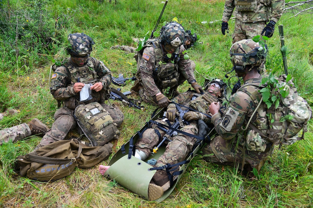 Army paratroopers evacuate a mock casualty during Exercise Rock Knight at Pocek Range in Postonja, Slovenia, July 24, 2017. Army photo by Paolo Bovo