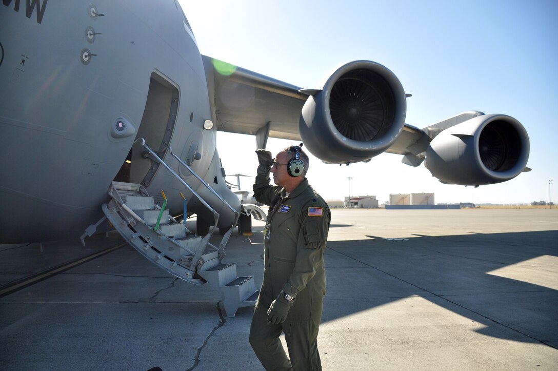 Lt. Col. William Wickersham, 301st Airlift Squadron C-17 Globemaster III pilot, performs a pre-flight inspection July 22, 2017 at Travis Air Force Base, Calif. The aircraft would later perform low-level fying and terrain-masking techniques as part of the 349th Air Mobility Wing's Patriot Wyvern exercise. (U.S. Air Force photo by Senior Airman Shelby R. Horn/Released)