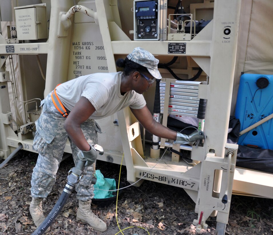Spc. Christina Smallwood, a petroleum supply specialist with the 316th Adjutant General Detachment out Fort Totten, New York, ungrounds a fueling nozzle from a Mobile Integrated Remains Collection System after fueling its generator at Fort Pickett, Virginia, July 16, 2017. The Army Reserve Soldier is participating in the 2017 Joint Mortuary Affairs Exercise along with active Army Soldiers, the Air Force and Marines.