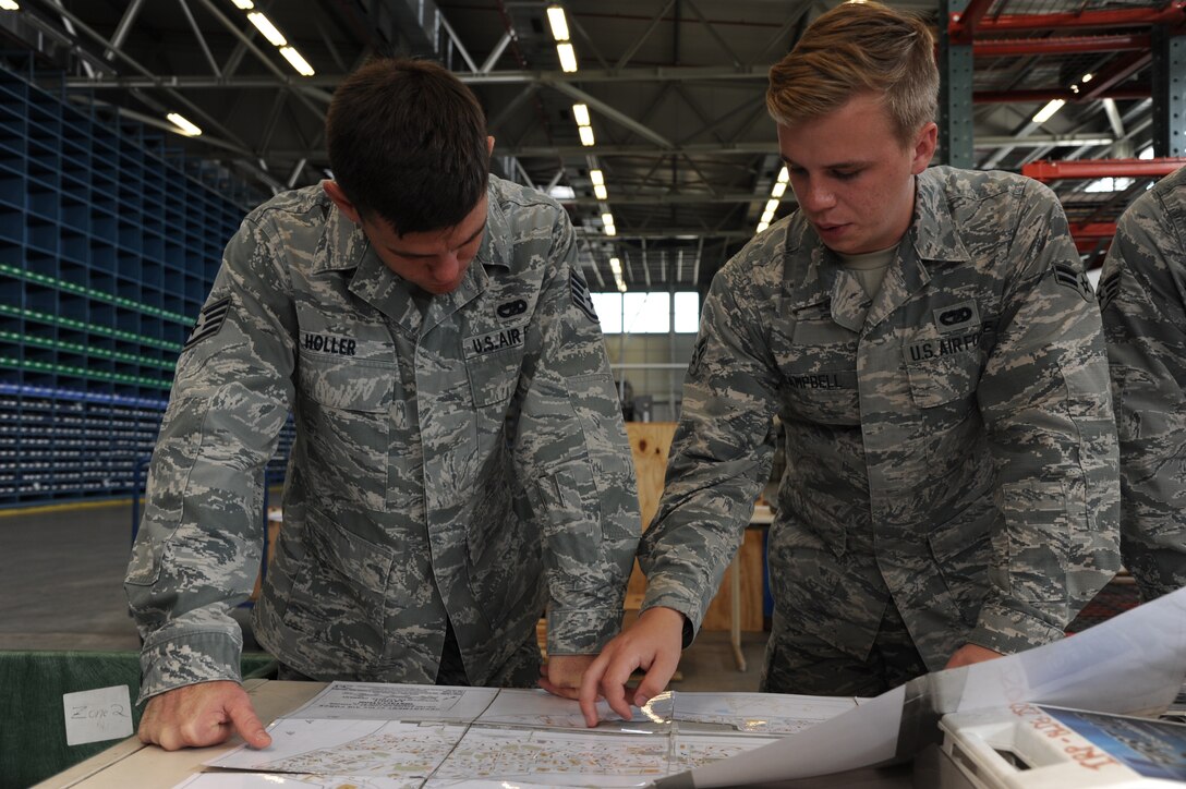 Staff Sgt. Dustin Holler, a vehicle operator specialist from the 927th Logistics Readiness Squadron, MacDill Air Force base, Florida, works alongside his active duty counterpart Airman 1st Class Austin Campbell, 52nd Logistics Readiness Squadron, Spangdahlem, Germany. Citizen Airmen from the 927 LRS, traveled to Spangdahlem Air Base, Germany, to perform their annual training, July 7-23, 2017. (U.S. Air Force photo by Tech. Sgt. Peter Dean)