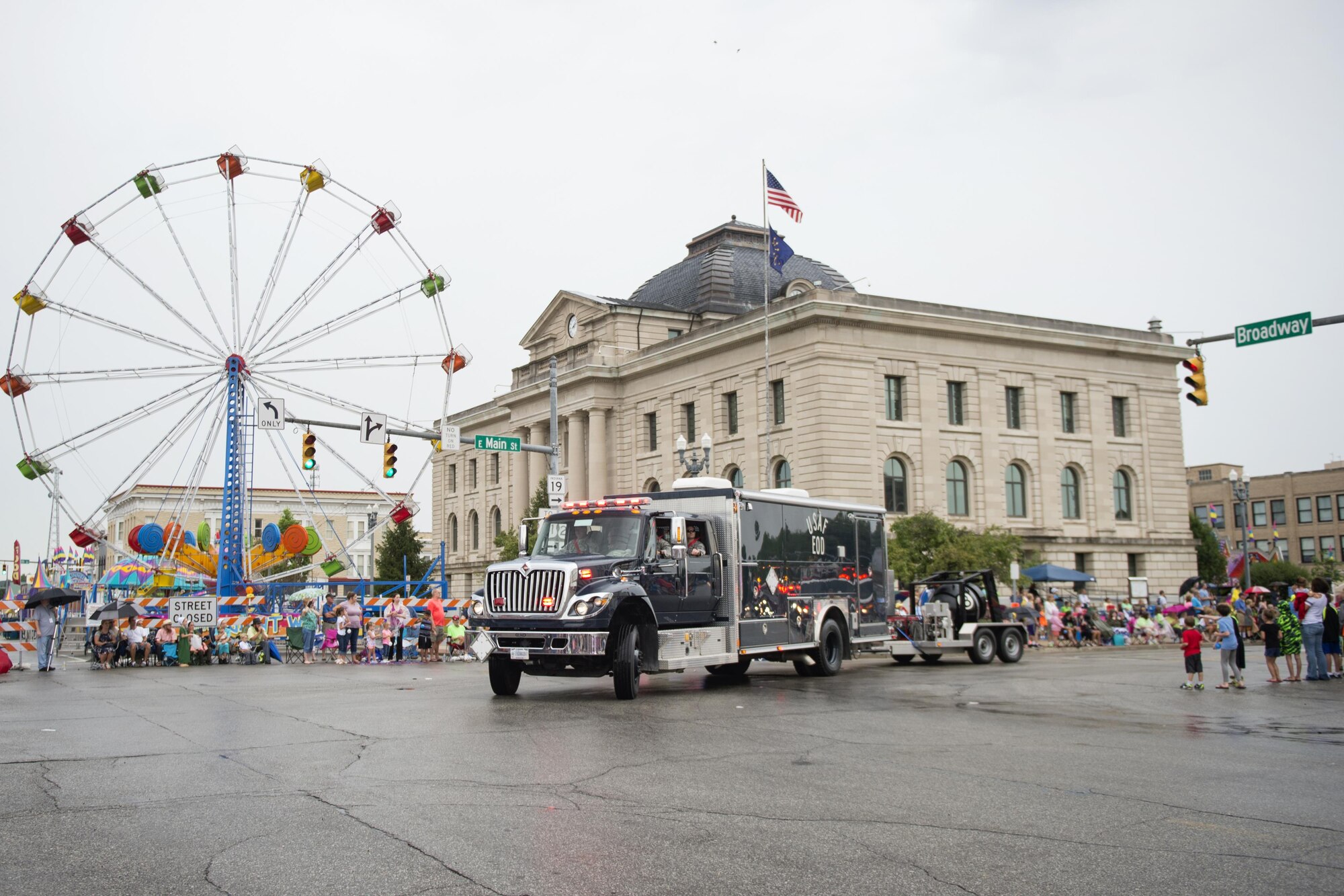 Members from the 434th Civil Engineer Squadron explosives ordnance disposal flight maneuver the unit’s EOD truck through crowd-lined city streets during the 58th Annual Circus City Festival parade in Peru, Ind. July 22, 2017. The parade is the world’s longest running circus parade and the second largest parade in Indiana. (U.S. Air Force photo/Tech. Sgt. Benjamin Mota)
