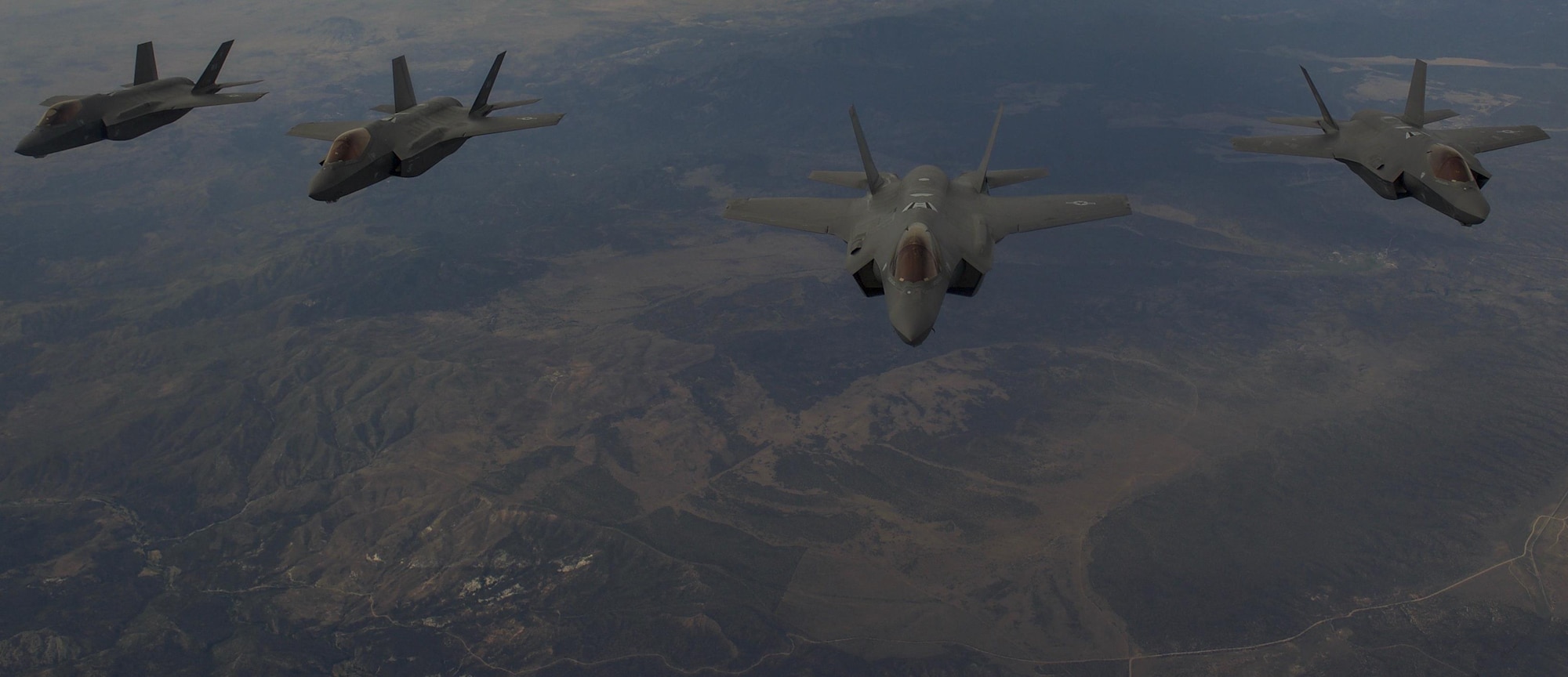 F-35 Lightning II fighter jets, assigned to the 6th Weapons Squadron, at Nellis Air Force Base, Nev., fly in formation over the Nevada Test and Training Range, Nev., July 10, 2017. The United States Air Force Weapons School teaches graduate-level instructor courses that provide the world's most advanced training in weapons and tactics employment to officers of the combat air forces and mobility air forces. (U.S. Air Force photo by Senior Airman Kevin Tanenbaum/Released)