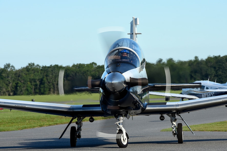 Capt. Dean Hall, 479th Flying Training Group T-6A Texan pilot, Naval Air Station Pensacola, Fla., taxis the runway during the Eyes Above the Horizon diversity outreach program, July 22, 2017, in Valdosta, Ga. The Valdosta Regional Airport welcomed approximately 100 10-19-year-olds as they took the Valdosta skies to commemorate the 76th Anniversary of the historic Tuskegee Airmen. The EAH program focuses on mentoring and familiarizing underrepresented minorities with basic flying fundamentals. (U.S. Air Force photo by Senior Airman Greg Nash) 