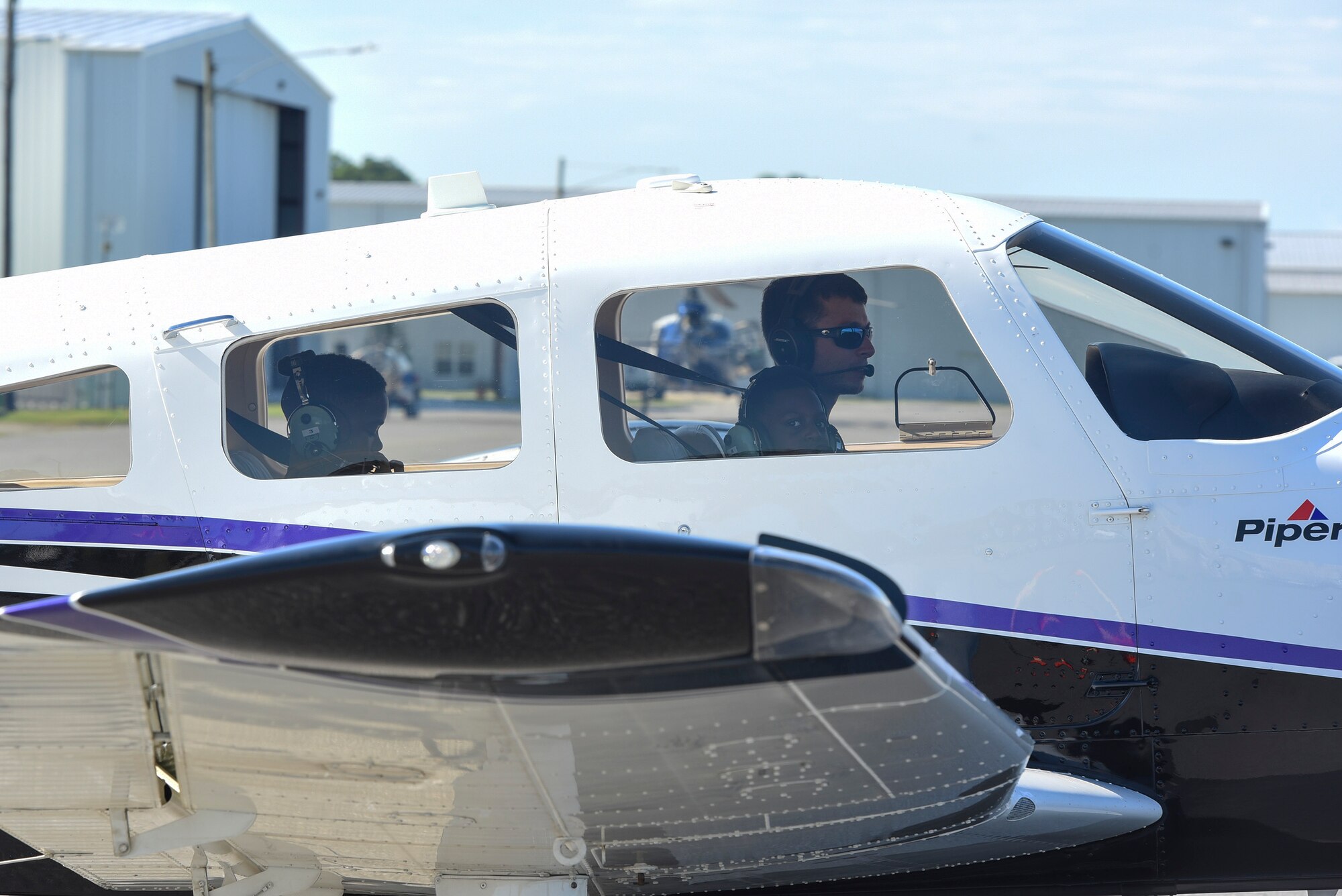 Local Valdosta youth await to takeoff in a Piper Archer aircraft during the Eyes Above the Horizon diversity outreach program, July 22, 2017, in Valdosta, Ga. The Valdosta Regional Airport welcomed approximately 100 10-19-year-olds as they took the Valdosta skies to commemorate the 76th Anniversary of the historic Tuskegee Airmen. The program focuses on mentoring and familiarizing underrepresented minorities with basic flying fundamentals. (U.S. Air Force photo by Senior Airman Greg Nash) 