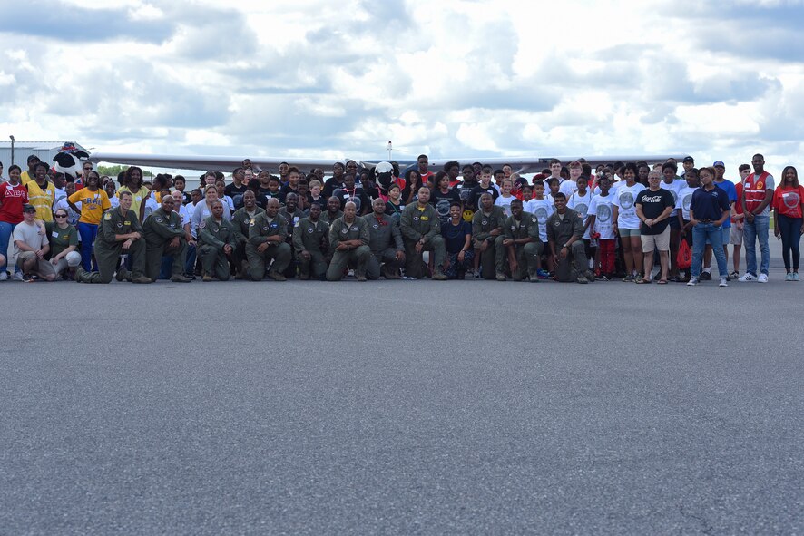 Local youth pose with collegiate advisors and Airmen during the Eyes Above the Horizon diversity outreach program, July 22, 2017, in Valdosta, Ga. Approximately 100 10-19-year-olds learned about aviation as they took the Valdosta skies to commemorate the 76th Anniversary of the historic Tuskegee Airmen. The program focuses on mentoring and familiarizing underrepresented minorities with basic flying fundamentals. (U.S. Air Force photo by Senior Airman Greg Nash)
