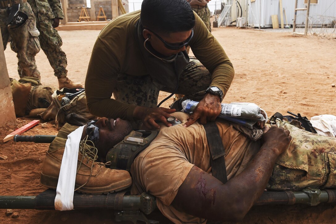 Navy Petty Officer 3rd Class David Rojas, a hospital corpsman, uses a stethoscope to listen to a patient’s heartbeat during a bilateral exercise with French forces in the Arta region on Camp Lemonnier, Djibouti, July 19, 2017. Air Force photo by Staff Sgt. Eboni Prince