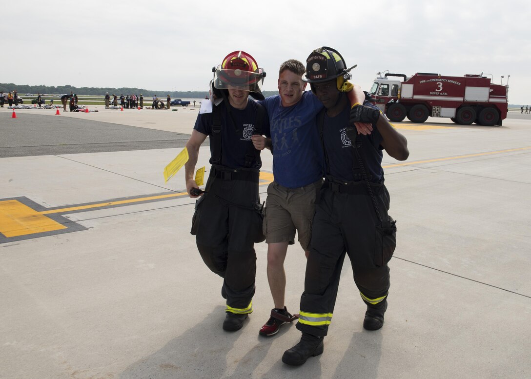 Dover Air Force Base firefighters assist a simulated casualty during a Major Accident Response Exercise July 22, 2017, on Dover AFB, Del. The simulated patients were transported to three local hospitals for medical treatment. (U.S. Air Force photo by Senior Airman Zachary Cacicia)