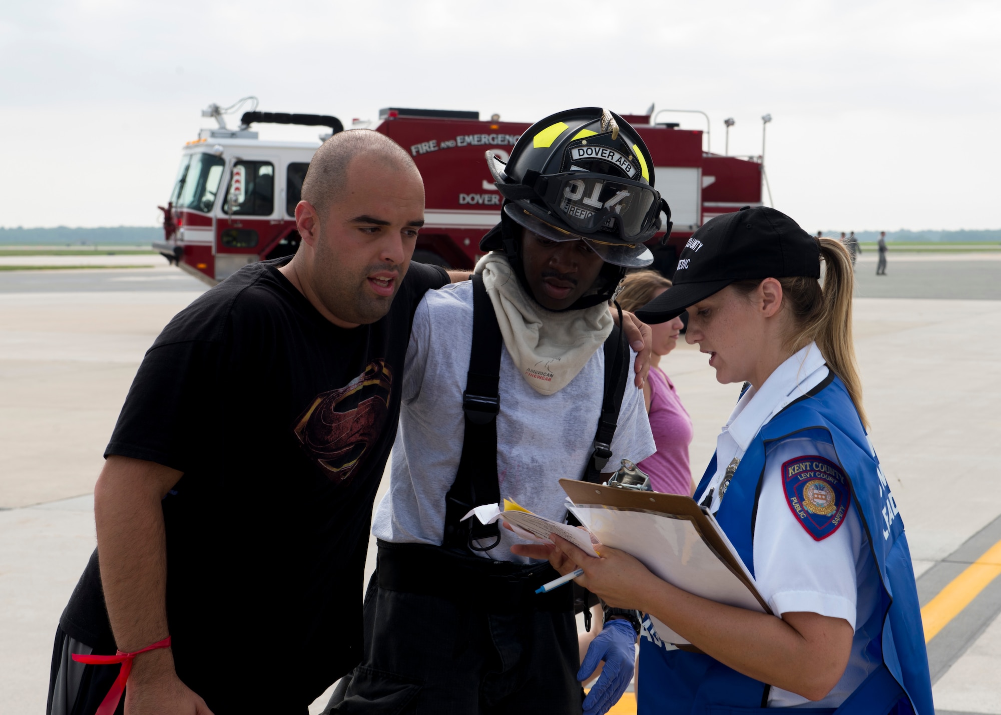 Dover Air Force Base firefighters and Kent County Public Safety personnel assist simulated casualties during a Major Accident Response Exercise July 22, 2017, on Dover AFB, Del. Countless Dover AFB units and off-base community partners worked hand-in-hand throughout the exercise ensuring the safety of attendees of the upcoming Open House. (U.S. Air Force photo by Senior Airman Zachary Cacicia)