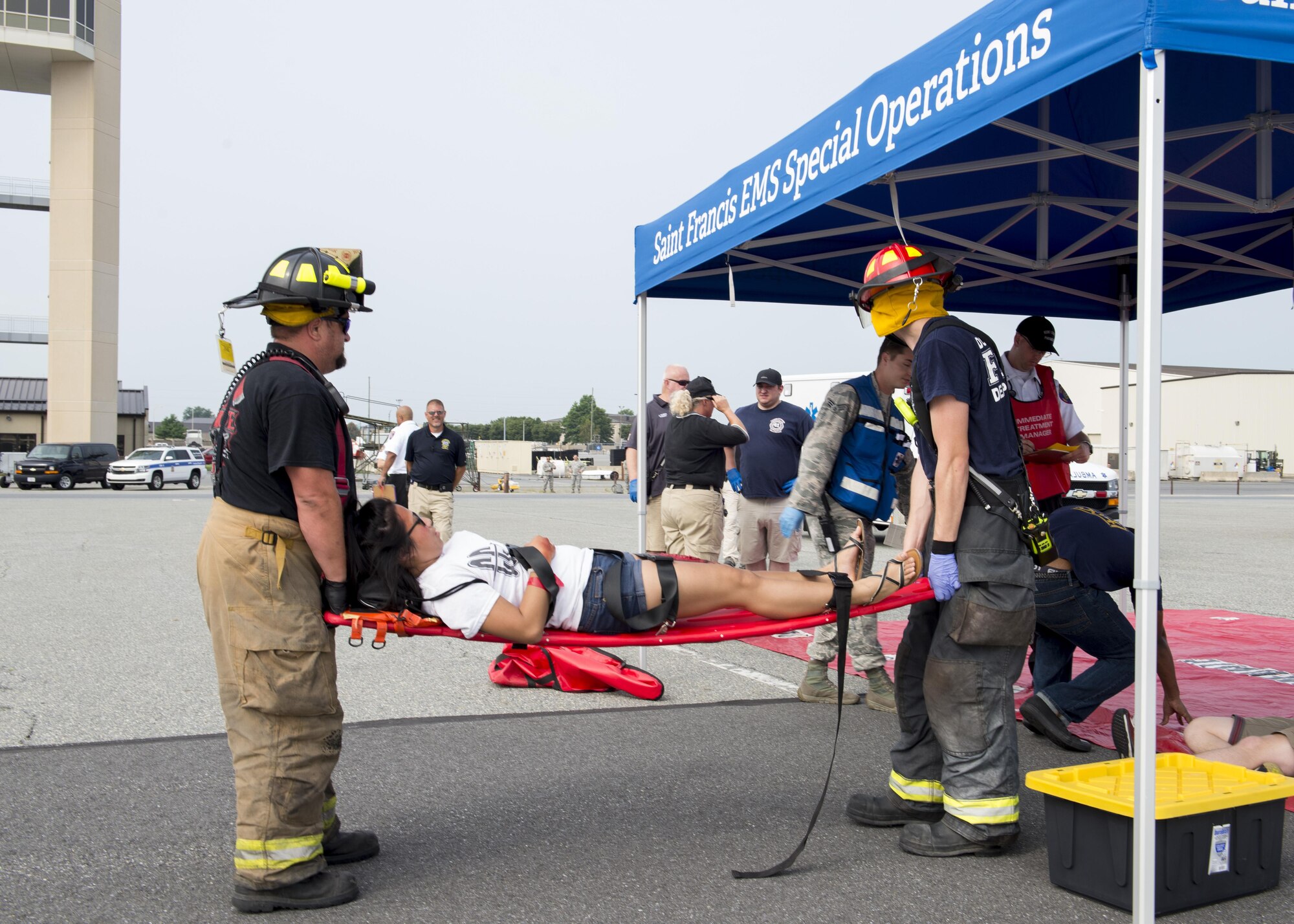 Dover Air Force Base and Frederica firefighters work together to assist a simulated casualty during a Major Accident Response Exercise July 22, 2017, on Dover AFB, Del. Seven off-base fire departments and emergency medical services stations took part in the exercise. (U.S. Air Force photo by Senior Airman Zachary Cacicia)
