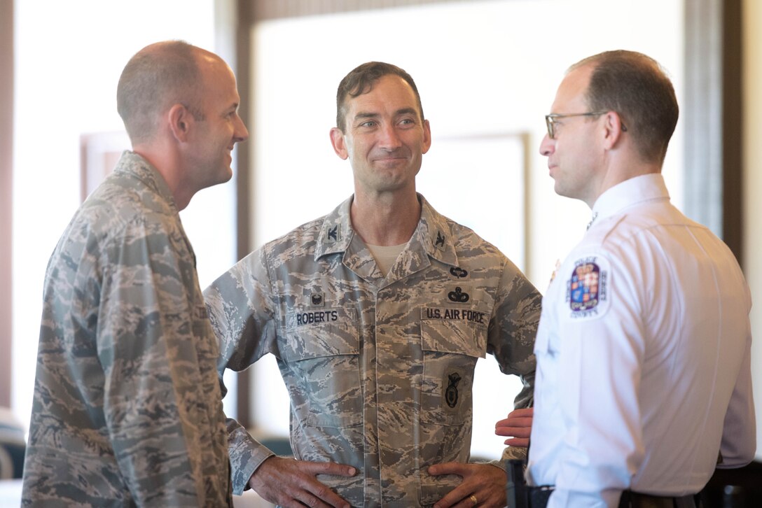 (Left to right) Col. John E. Teichert, 11th Wing and Joint Base Andrews commander, Col. Troy Roberts, 11th Security Forces Group commander and Hank Stawinski, Prince George’s County police chief have a conversation prior to the Joint Base Andrews 2017 Honorary Commander Immersion and Breakfast, July 25, 2017, at JBA, Md. The JBA Honorary Commander Program encourages an exchange of ideas and experiences, as well as partnerships between key leaders of the base's surrounding communities, JBA commanders and Airmen. (U.S. Air Force photo by Senior Airman Delano Scott)