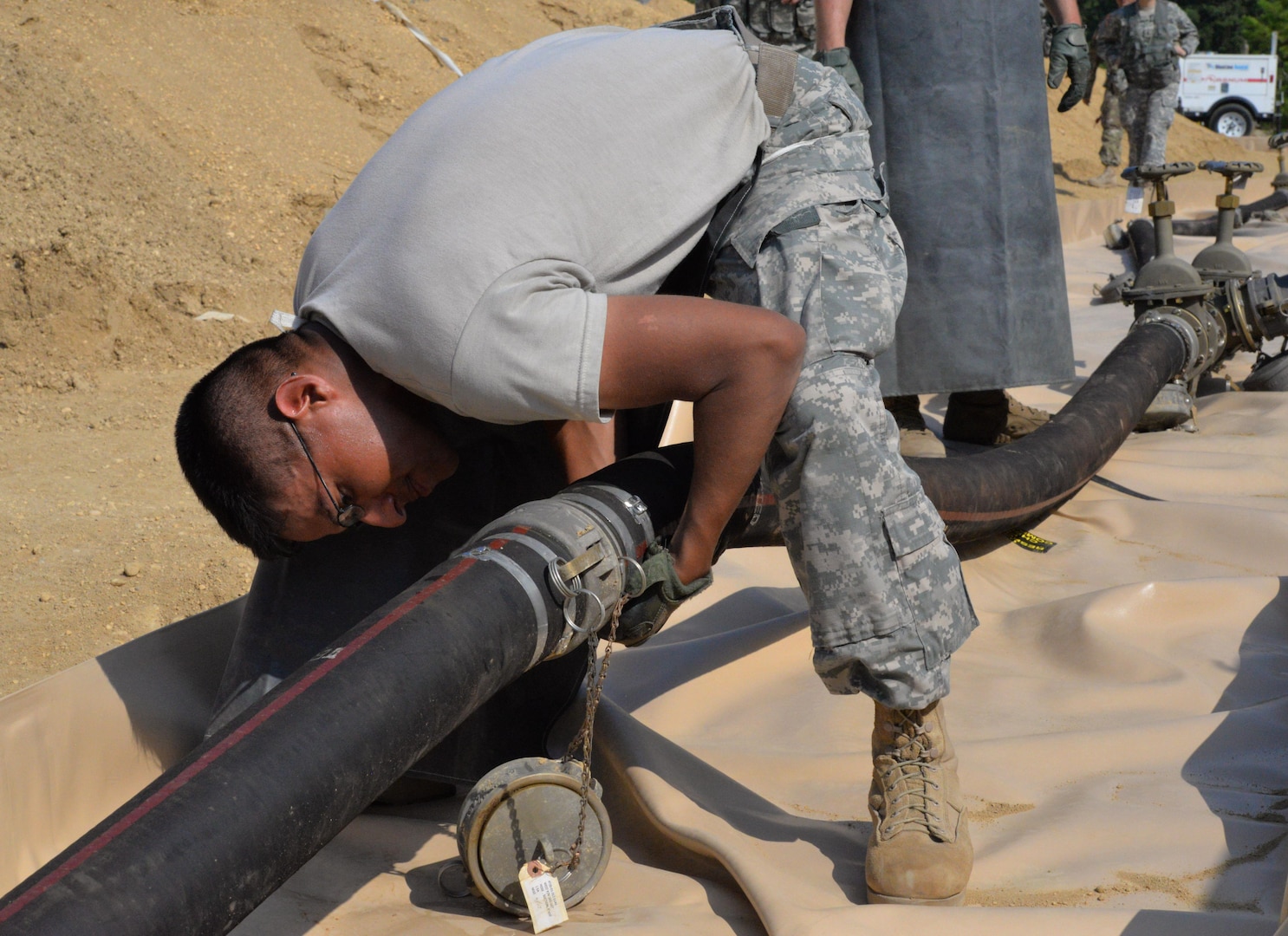 Army Sgt. Benjamin Santa Maria, 947th Quartermaster Company, checks for a fuel leak during a Quartermaster Liquid Logistic Exercise at Joint Base McGuire-Dix-Lakehurst, N.J., July 19, 2017. The exercise tested the Soldiers capability to safely and efficiently receive incoming fuel trucks and download thousands of gallons fuel. Once the fuel was received, the Soldiers cleaned and recirculated it before refilling trucks awaiting resupply. 