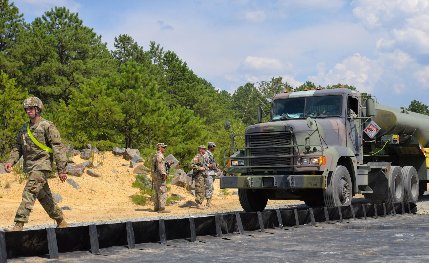 Soldiers with the 947th Quartermaster Company, Chambersburg, PA, receive a fuel truck at a fuel system supply point during a Quartermaster Liquid Logistic Exercise at Joint Base McGuire-Dix-Lakehurst, N.J., July 19, 2017. QLLEX is a multicomponent operation that allows reserve units to conduct real-world petroleum and water purification support in a combat training environment.