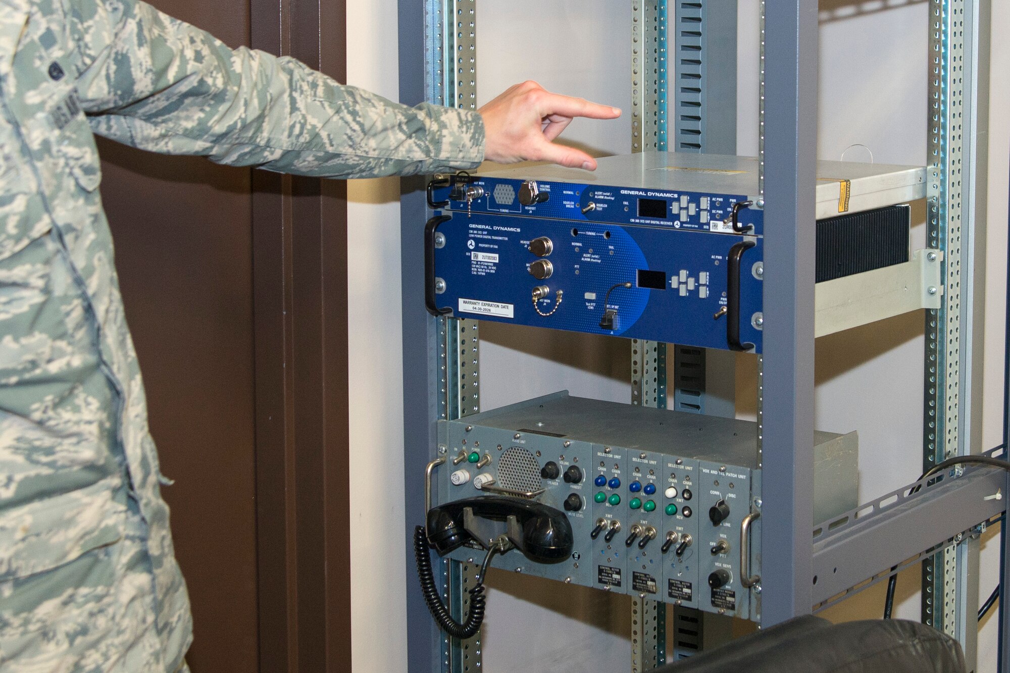 Senior Airman Cory Brundage, 436th Operations Support Squadron airfield systems journeymen, explains how the new radios will be arranged in the racks April 28, 2017, on Dover Air Force Base, Del. ADB Companies and the 436th OSS’s Air Traffic Control and Landing Systems worked tirelessly to install $540 thousand worth of state-of-the-art radios, replacing equipment that dates to the 1950s and consolidates transmission and reception sites to a single facility, called the Ground to Air Transmit Receive site or GATR. (U.S. Air Force photo by Staff Sgt. Jared Duhon)