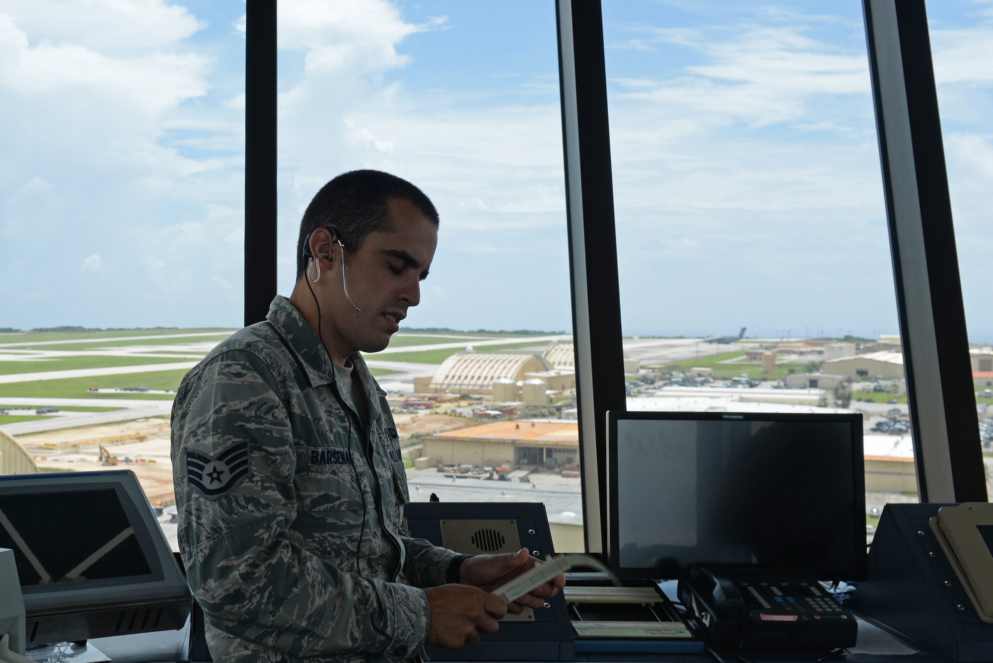 U.S. Air Force Staff Sgt. Nicholas Barsenas, 36th Operation Support Squadron air traffic controller, speaks with pilots on July 17, 2017, at Andersen Air Force Base, Guam. Air traffic control Airmen assigned to the 36th Operation Support Squadron began work in the new tower cab here June 30 after spending almost three months working in the mobile tower unit on the flightline. (U.S. Air Force photo by Airman 1st Class Gerald Willis)