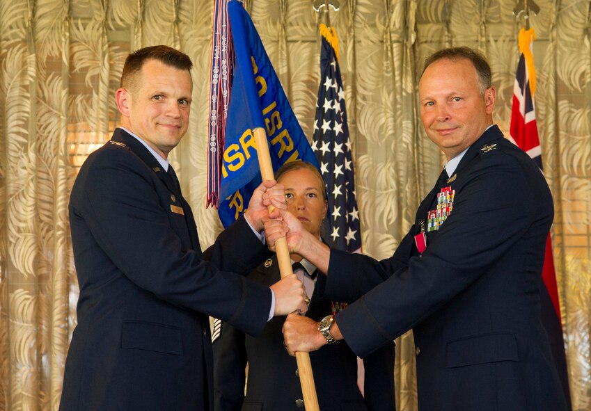 Col. Jason Brown, 480th Intelligence, Surveillance and Reconnaissance Wing commander, takes the group flag from Col. Chad Hartman, former commander of the 692nd Intelligence, Surveillance and Reconnaissance Group, during the 692 ISRG Change of Command Ceremony, Joint Base Pearl Harbor-Hickam, Hawaii, July 17, 2017. The 692 ISRG, headquartered at Joint Base Pearl Harbor-Hickam, Hawaii, processes, exploits and disseminates ISR data collected by U-2 Predator, and Global Hawk aircraft. (U.S. photo by Tech. Sgt. Heather Redman)