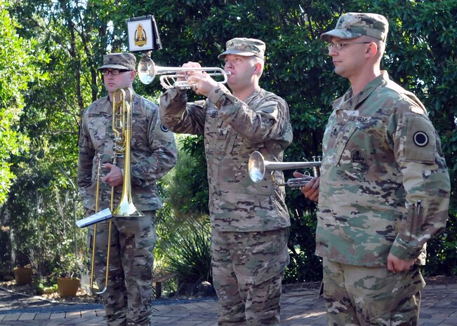 Sgt. Mark Koehl, an army musician, American’s First Corps Army Band, plays “Rouse” while Sgt. 1st Class Todd Borges, music performance team leader, Staff Sgt. Brandon Egner, assistant music performance team leader, stand at attention, during a memorial service at Enoggera, Australia, during Talisman Saber July 17, 2017. “Rouse” is what Australian soldiers play when raising their national colors. (U.S. Army photo by Sgt. Debrah Sanders, 366th Mobile Public Affairs Detachment)