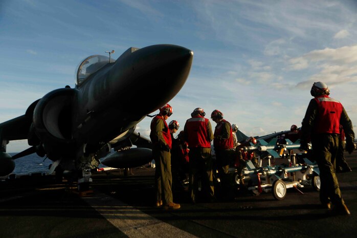 PACIFIC OCEAN – Aviation Ordnance Marines stand by to load laser guided training rounds (LGTR) on AV-8B Harriers aboard the amphibious assault ship USS America (LHA 6), July 16, 2017. The 15th Marine Expeditionary Unit and America Amphibious Ready Group Team is currently deployed to the 3rd, 5th and 7th fleet areas of responsibility as a crisis response and contingency force. (U.S. Marine Corps photo by Lance Cpl. Jacob Pruitt)