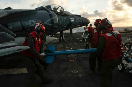 PACIFIC OCEAN – Aviation Ordnance Marines with Marine Medium Tiltrotor Squadron 161 (Reinforced), secure a laser guided training round (LGTR) onto an AV-8B Harrier aboard amphibious assault ship USS America (LHA 6), July 16, 2017. The 15th Marine Expeditionary Unit and America Amphibious Ready Group Team is currently deployed to the 3rd, 5th and 7th fleet areas of responsibility as a crisis response and contingency force.  (U.S. Marine Corps photo by Lance Cpl. Jacob Pruitt)