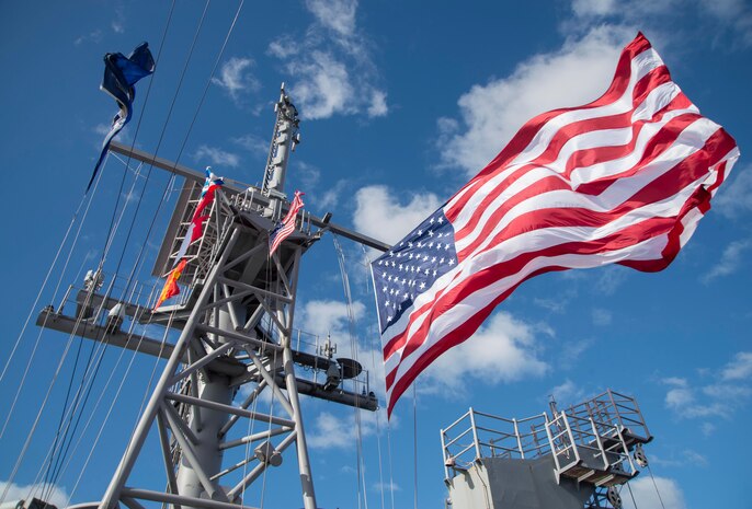 170722-N-YG104-018 CORAL SEA (July 22, 2017) The battle flag and battle ensign fly on the masts of the amphibious assault ship USS Bonhomme Richard (LHD 6) as the ship steams along as ships from the U.S., Australia, and New Zealand sail together in formation to culminate Talisman Saber 17. Talisman Saber is a biennial U.S. bilateral exercise held off the coast of Australia meant to achieve interoperability and strengthen the U.S.-Australia alliance. (U.S. Navy photo by Mass Communication Specialist 2nd Class Sarah Villegas/Released)