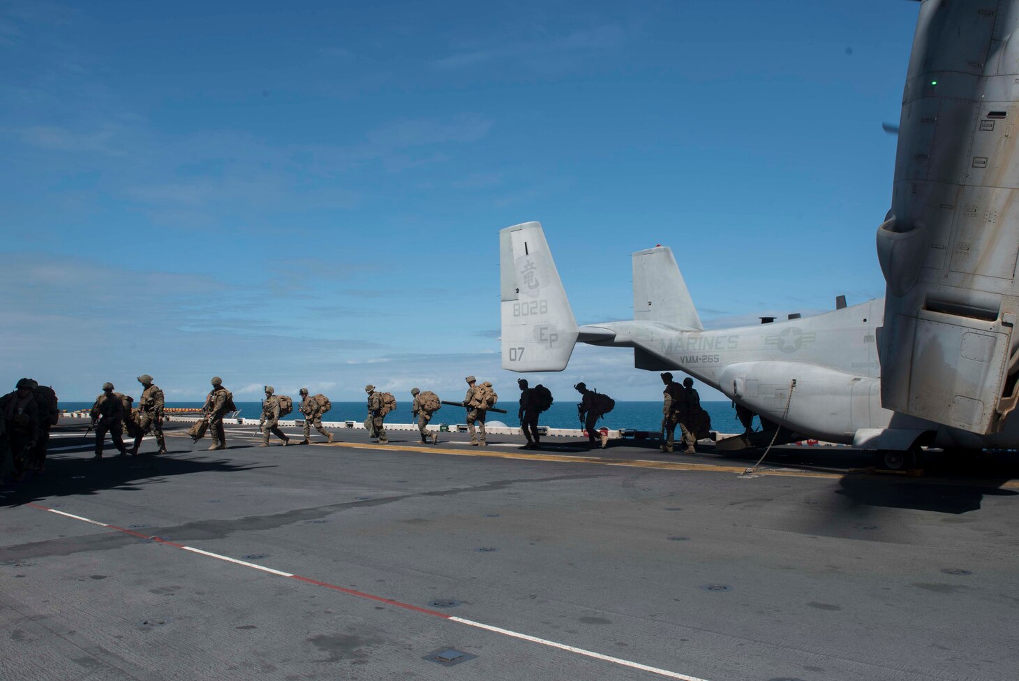 170723-N-NB544-576 CORAL SEA (July 23, 2017) Marines, assigned to the 31st Marine Expeditionary Unit (MEU), disembark an MV-22B Osprey, assigned to the “Dragons” of Marine Medium Tiltrotor Squadron (VMM) 265 (Reinforced), on the flight deck of the amphibious assault ship USS Bonhomme Richard (LHD 6) after training with the Australia Army in the Shoalwater Bay Training Area as part of Talisman Saber 17. Talisman Saber is a biennial U.S.-Australian bilateral exercise held off the coast of Australia meant to achieve interoperability and strengthen the U.S.-Australian alliance. (U.S. Navy photo by Mass Communication Specialist 2nd Class Kyle Carlstrom/Released)