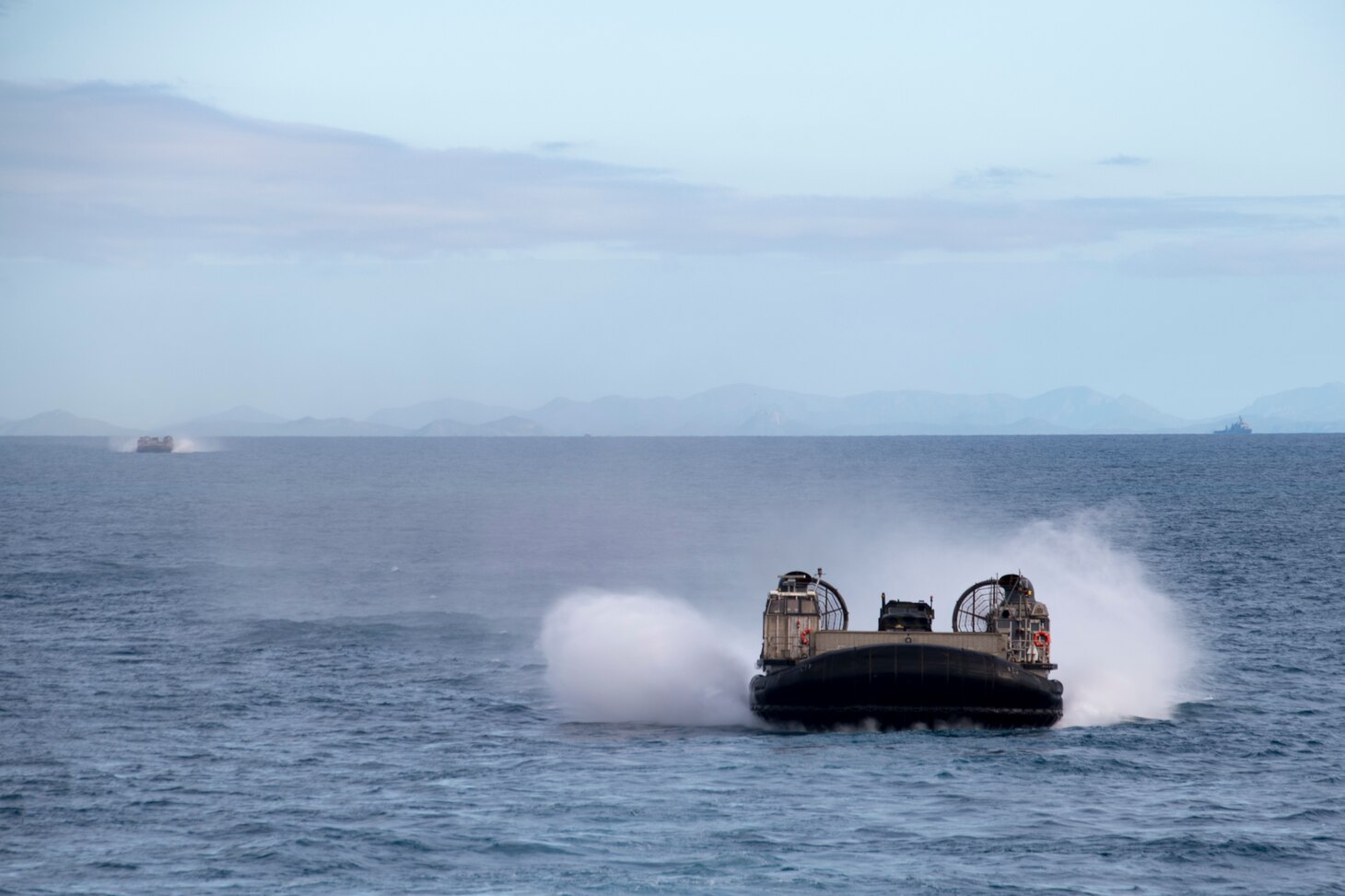 170723-N-XK809-216 CORAL SEA (July 23, 2017) Landing craft air cushions (LCAC), assigned to Naval Beach Unit (NBU) 7, approach the well deck of the amphibious assault ship USS Bonhomme Richard (LHD 6) as Marines of the 31st Marine Expeditionary Unit (MEU) return from training with the Australia Army in the Shoalwater Bay Training Area as part of Talisman Saber 17. Talisman Saber is a biennial U.S.-Australian bilateral exercise held off the coast of Australia meant to achieve interoperability and strengthen the U.S.-Australian alliance. (U.S. Navy photo by Mass Communication Specialist 3rd Class William Sykes/Released)