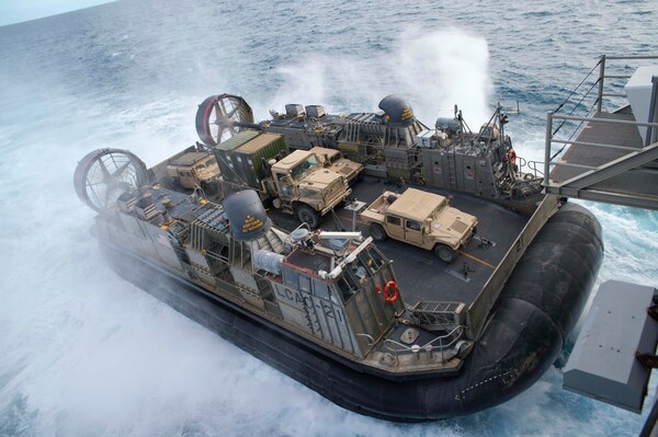 170723-N-XK809-329 CORAL SEA (July 23, 2017) Landing craft air cushion (LCAC) 21, assigned to Naval Beach Unit (NBU) 7, approaches the well deck of the amphibious assault ship USS Bonhomme Richard (LHD 6) as Marines of the 31st Marine Expeditionary Unit (MEU) return from training with the Australia Army in the Shoalwater Bay Training Area as part of Talisman Saber 17. Talisman Saber is a biennial U.S.-Australian bilateral exercise held off the coast of Australia meant to achieve interoperability and strengthen the U.S.-Australian alliance. (U.S. Navy photo by Mass Communication Specialist 3rd Class William Sykes/Released)