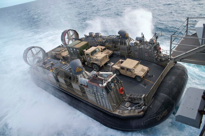 170723-N-XK809-329 CORAL SEA (July 23, 2017) Landing craft air cushion (LCAC) 21, assigned to Naval Beach Unit (NBU) 7, approaches the well deck of the amphibious assault ship USS Bonhomme Richard (LHD 6) as Marines of the 31st Marine Expeditionary Unit (MEU) return from training with the Australia Army in the Shoalwater Bay Training Area as part of Talisman Saber 17. Talisman Saber is a biennial U.S.-Australian bilateral exercise held off the coast of Australia meant to achieve interoperability and strengthen the U.S.-Australian alliance. (U.S. Navy photo by Mass Communication Specialist 3rd Class William Sykes/Released)