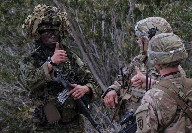 Paratroopers of 4th Infantry Brigade Combat Team, 25th Infantry Division communicate friendly unit locations with Japan Ground Self-Defense Force paratroopers using hand and arm signals during Exercise Talisman Saber in Shoalwater Bay Training Area, Australia July 14. (U.S. Army Photo by Staff Sgt. Daniel Love)