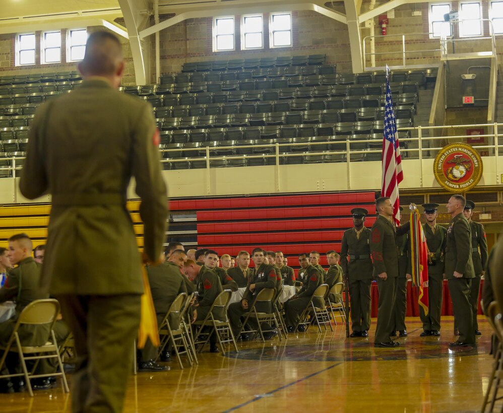 A Marine carrying an award streamer approaches the unit colors during the rededication ceremony at Camp Lejeune, N.C., July 21, 2017. Marines celebrated their unit’s 100-year anniversary with a rededication ceremony, dinner and a night of shared camaraderie. The Marines are with 1st Battalion, 6th Marine Regiment. (U.S. Marine Corps photo by Lance Cpl. Leynard Kyle Plazo)