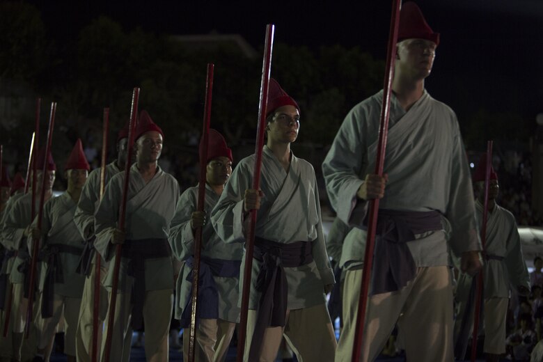 Marines with the Single Marine Program stood ready to perform during “The Picture Scrolls of the Three Great Urasoe Kings” in the 40th Annual Tedako Matsuri Festival July 22 in Urasoe City, Okinawa, Japan. Tedako means child of the sun. During this festival, respects are paid to King Eiso, a powerful king of the Ryukyu Kingdom.