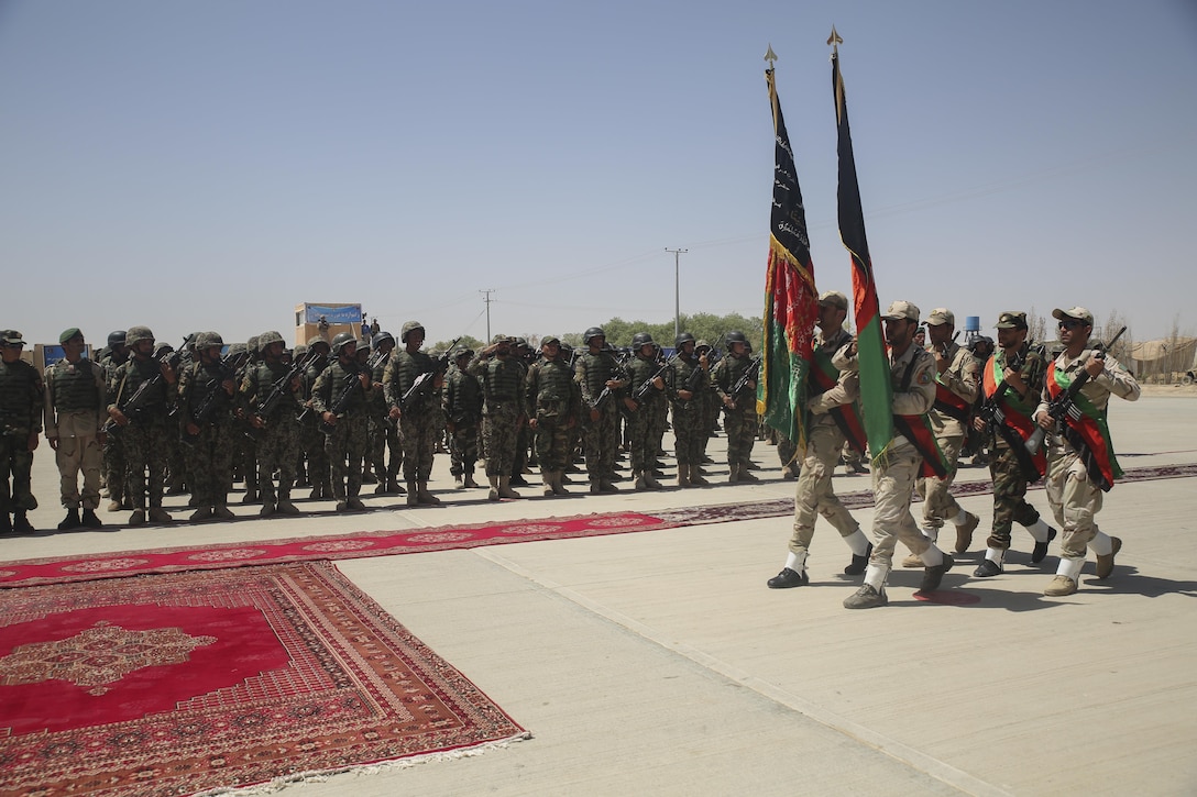The Afghan National Army 215th Corps color guard marches the Afghan national colors during a graduation ceremony at Camp Shorabak, Afghanistan, July 24, 2017.  Approximately 600 soldiers with 2nd Kandak, 4th Brigade, 215th Corps completed an eight-week operational readiness cycle at the Helmand Province Regional Military Training Center with assistance from U.S. Marine advisors assigned to Task Force Southwest. Throughout the course, the soldiers learned infantry tactics and weapons techniques in order to enhance their warfighting capabilities. (U.S. Marine Corps photo by Sgt. Lucas Hopkins)